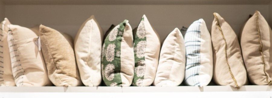 A run of throw pillows and textiles in the showroom